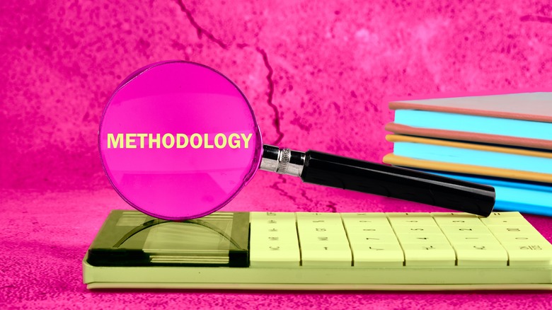 Pink methodology magnifyinc glass with notebooks