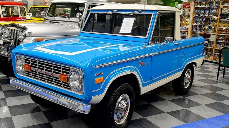 Blue 1977 Ford Bronco in a showroom