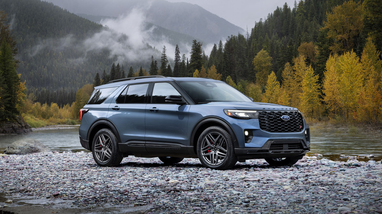 2025 Ford Explorer parked near a stream in the woods