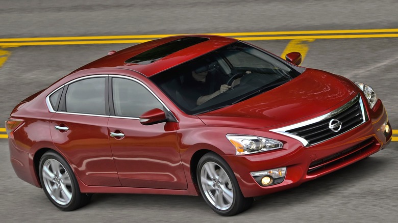 2013 red Nissan Altima street driving