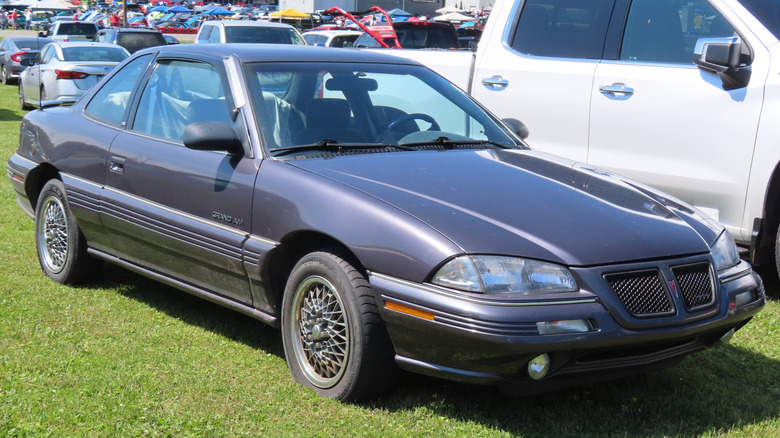 Gray 1993 Pontiac Grand Am parked on grass