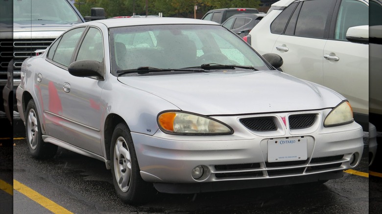 Silver 2003 Pontiac Grand Am in parking lot