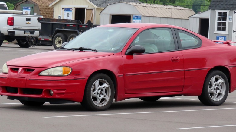 Red 2005 Pontiac Grand Am in parking lot