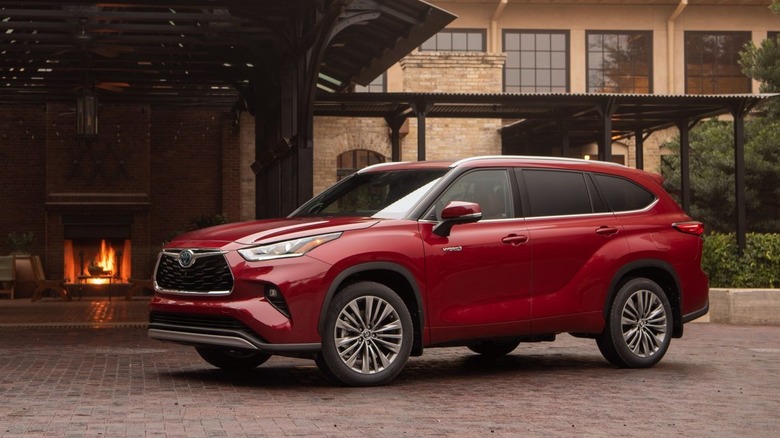 A red 2020 Toyota Highlander Hybrid parked on a driveway