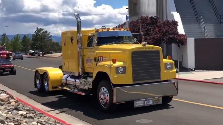 Jim and Alice Sercombe's 1975 Big Horn In yellow driving on road