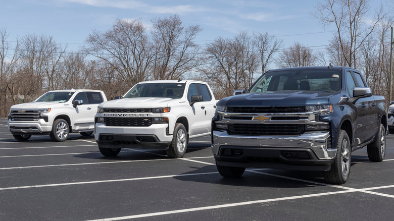 A series of Chevrolet pickup trucks in a parking lot