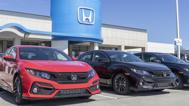 Honda Civic cars parked outside a dealership