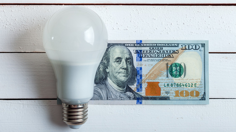 LED bulb next to $100 bill