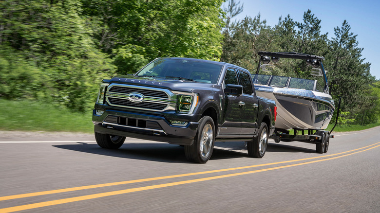 A 2020 Ford F-150 hauling a boat on a highway