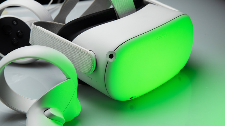 Meta Quest 2 VR headset and controllers illuminated in green lighting