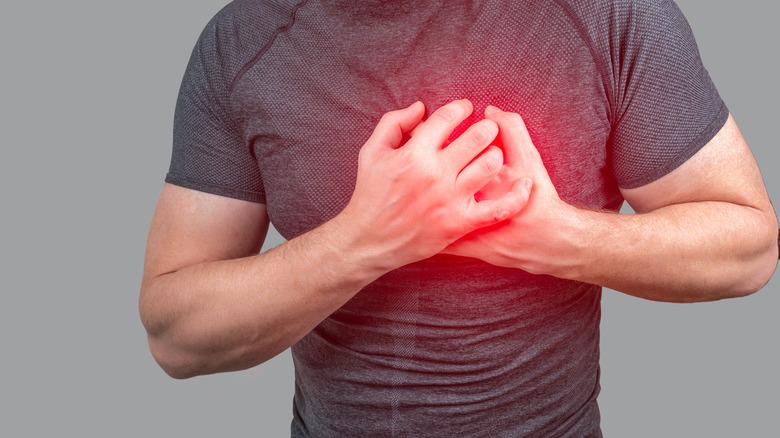 Man clutches chest in pain