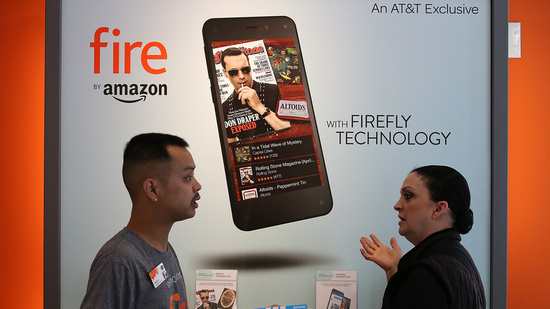 AT&T store worker with Amazon Fire Phone poster