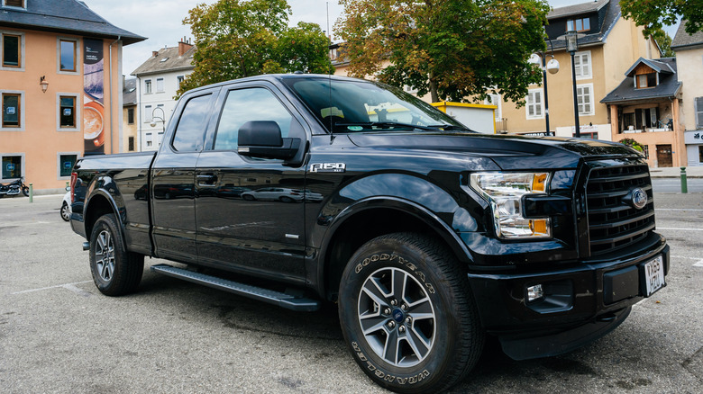 Black Ford F-150 truck parked in street