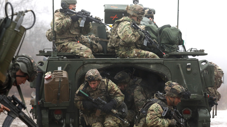 Soldiers exiting a Stryker vehicle