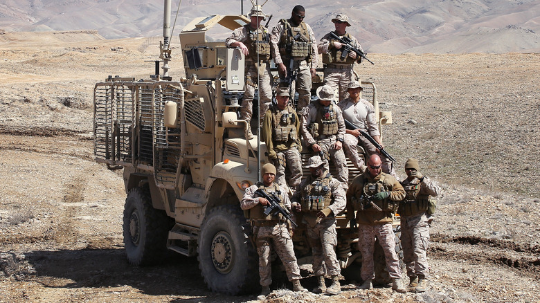 Seabees posing with an MRAP