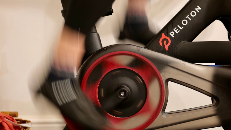 Cyclist on a Peloton bike with logo