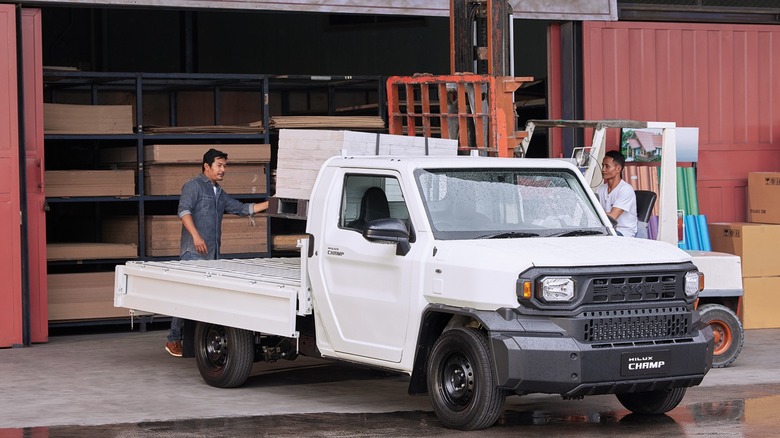 Men loading cargo onto a Toyota Hilux Champ