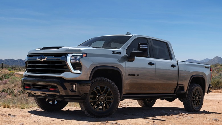 Silver Chevrolet Silverado HD Trail Boss parked on dirt