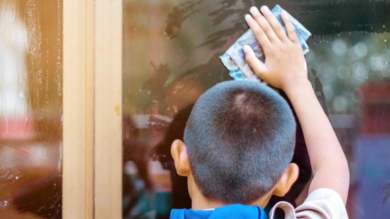 cleaning window with newspaper