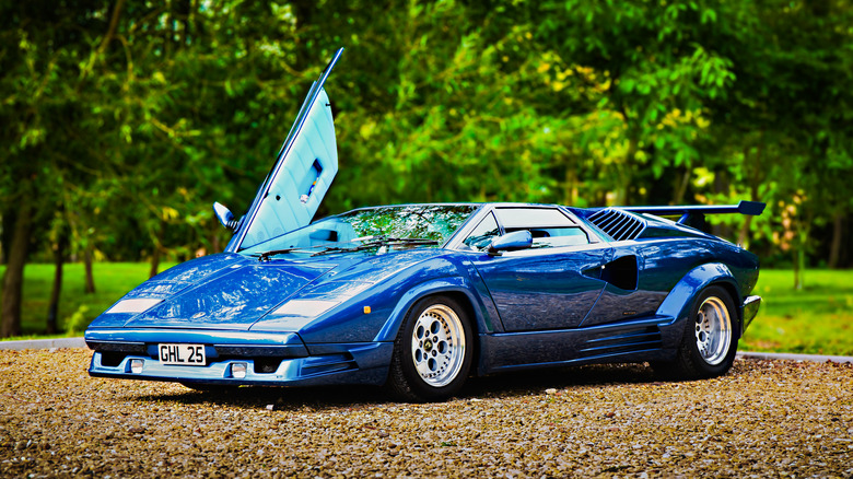 Blue Lamborghini Countach with one door open front 3/4 view