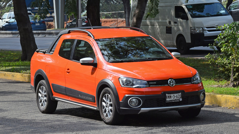 A Volkswagen Saveiro in orange, front 3/4 view