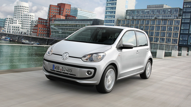 The Volkswagen up! in silver on the move, front 3/4 view