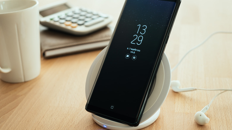 A Samsung smartphone on a wireless charging dock