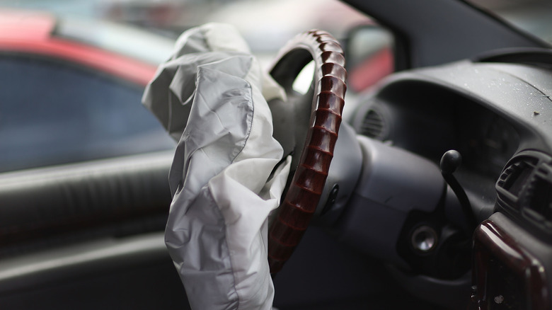 A deployed airbag seen at a salvage yard