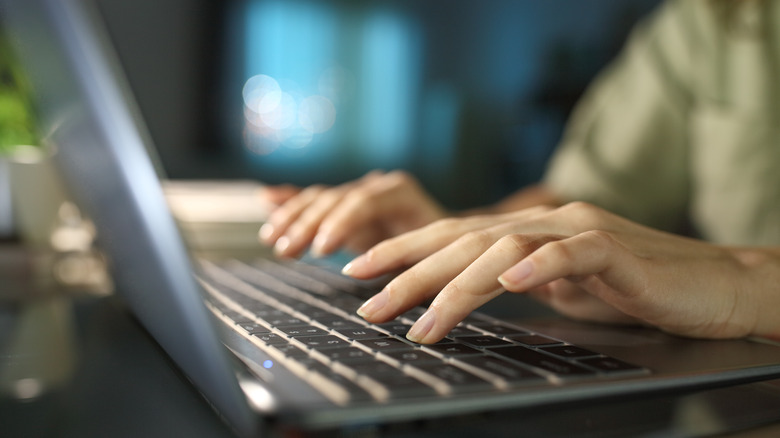 woman typing on laptop