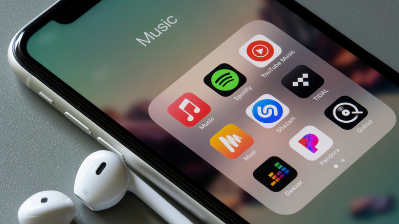 iPhone with music apps folder open