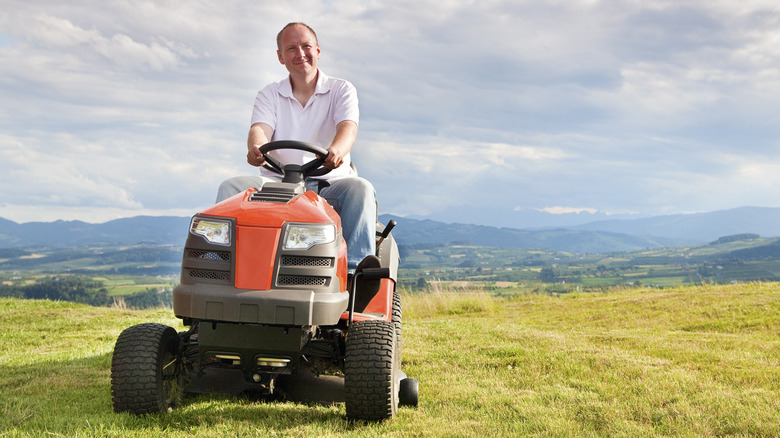 Man on riding lawn mower