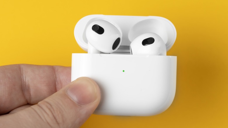 AirPods in hands of user.