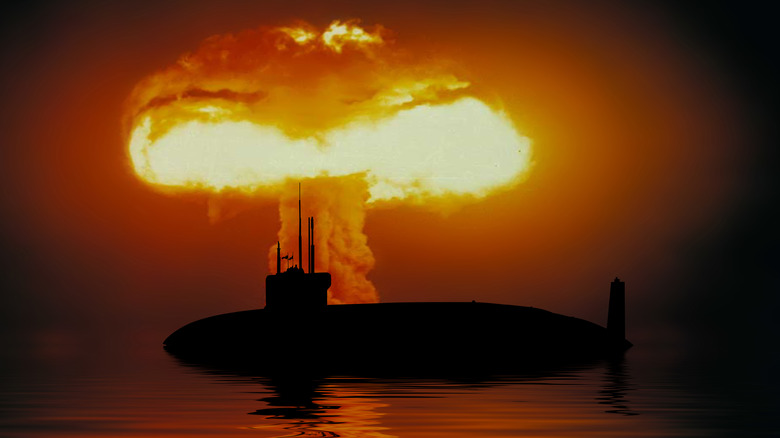 Mushroom cloud behind nuclear submarine