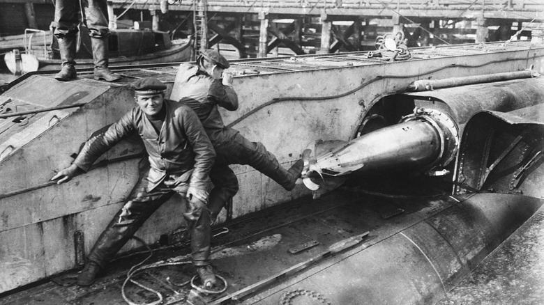 Crewman loading a torpedo WWI uboat