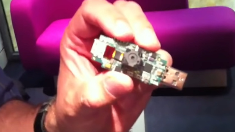 David Braben holding a Raspberry Pi prototype