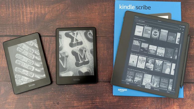 Amazon Kindle, Kindle Paperwhite, and Kindle Scribe on wooden table