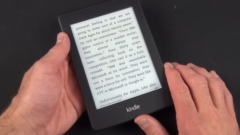 Hands holding Amazon Kindle Paperwhite 2