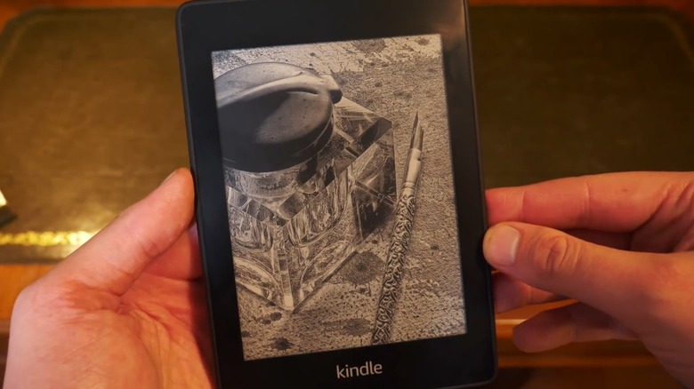 Hands holding Amazon Kindle Paperwhite 4