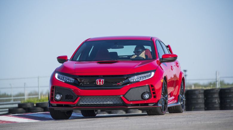 The FK8 Honda Civic Type R in red on the race track, front 3/4 view