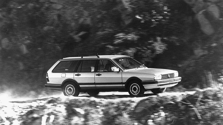 A Volkswagen Quantum wagon driving down a dirt trail, front 3/4 view