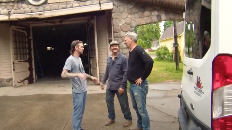 "American Pickers" stars Robbie Wolfe and Jersey Jon Szalay stand in front of W.J. Moore's "smart home"