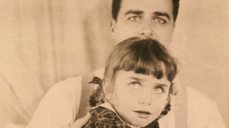 Edwin Land holding his daughter