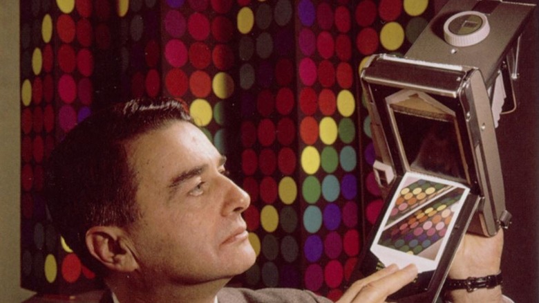Edwin Land displaying color film