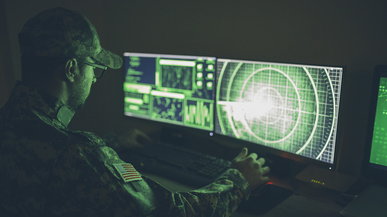 A soldier looking at radar.