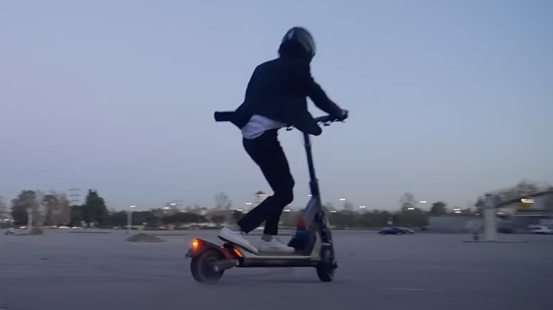 Helmeted rider on Segway GT-series scooter on city plaza