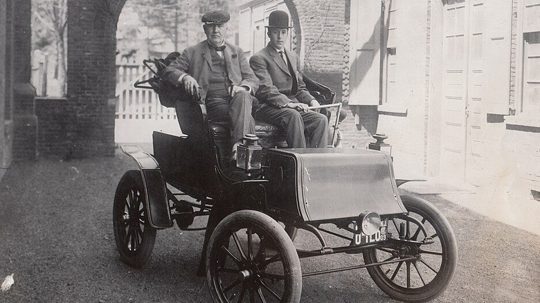 Thomas Edison and man sitting in electric Studebaker wagon