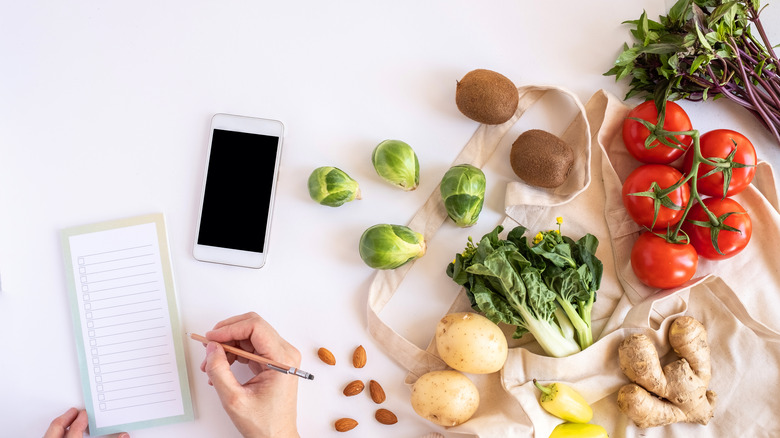 smartphone, notebook and grocery items 