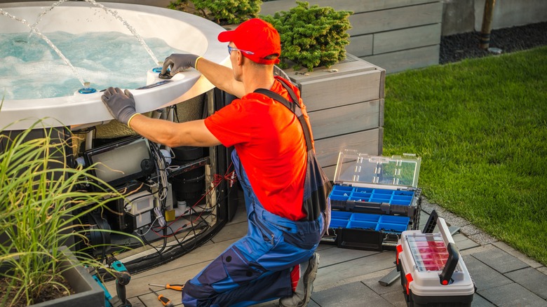 person servicing hot tub