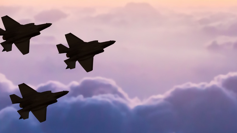 Three F-35 jets in silhouette