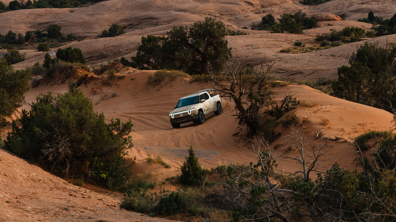 A Rivian makes it way through the desert